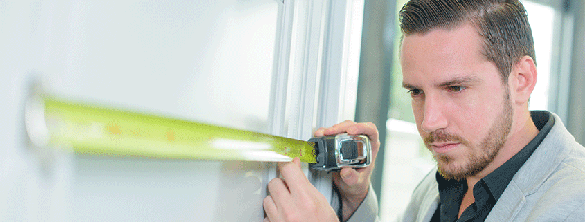 Man measure door with yellow tape