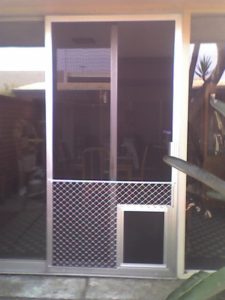 pet entrance or doggy door installed in a sliding glass door